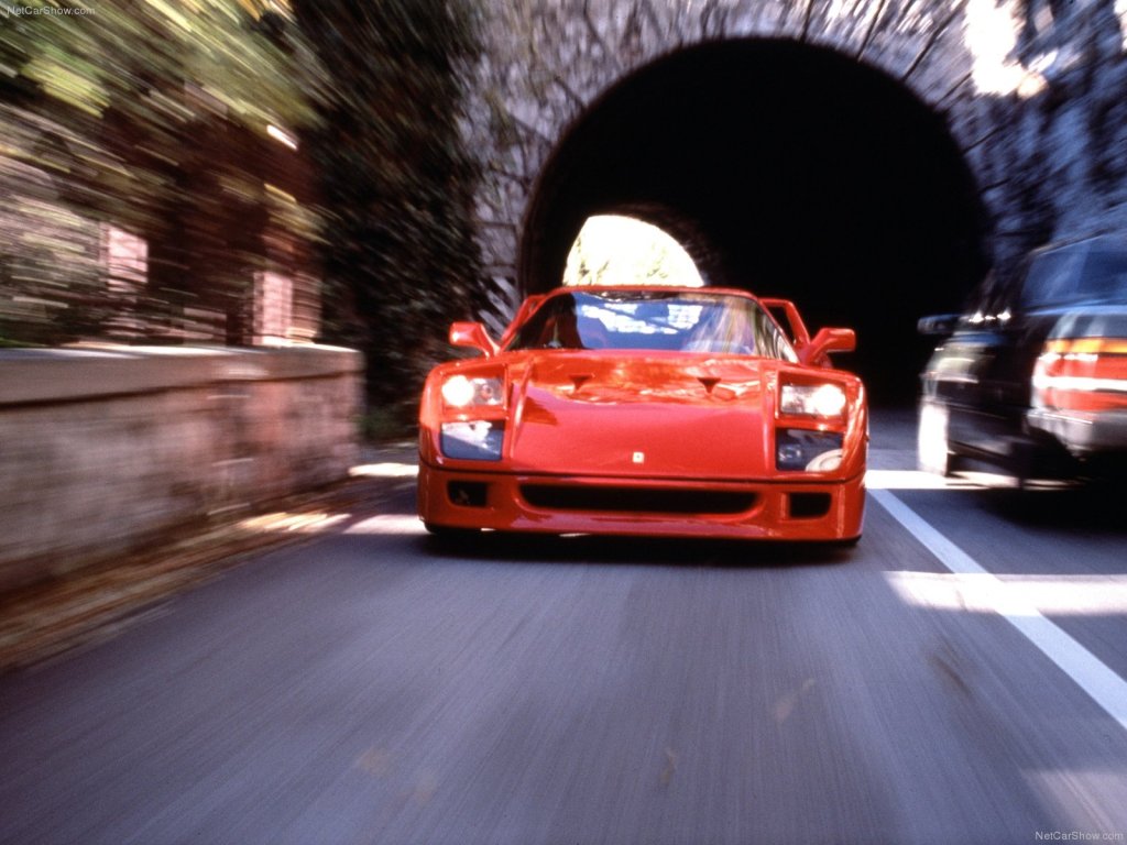 An image of a red Ferrari F40 outdoors.