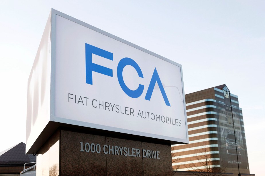 A blue FCA logo on a white sign outside the company's corporate headquarters in Michigan