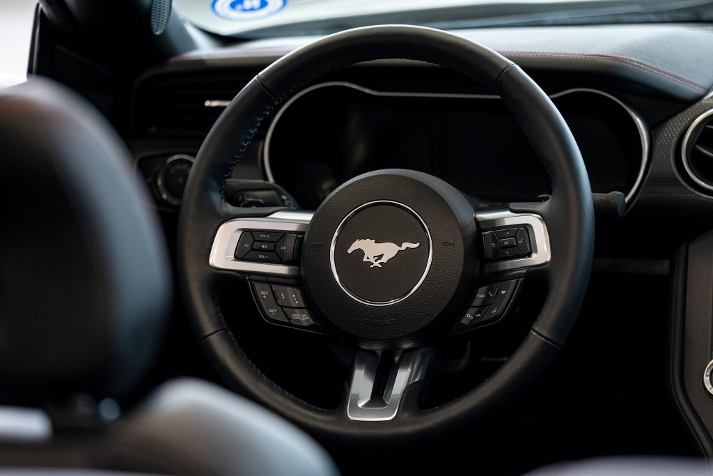 the steering wheel of a Ford Mustang on display at a dealership