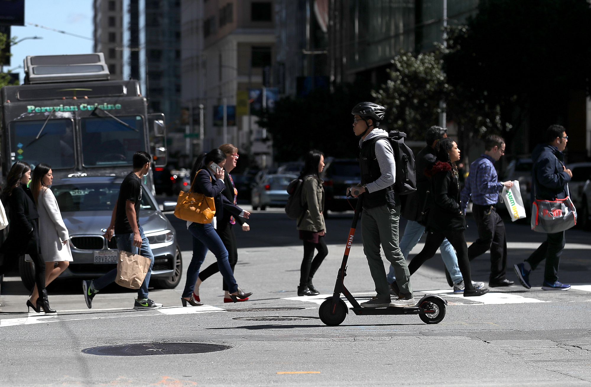 A person rides a Spin e-scooter in San Francisco