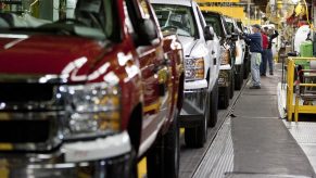 Chevy Silverado and GMC Sierra trucks being inspected on the assembly line