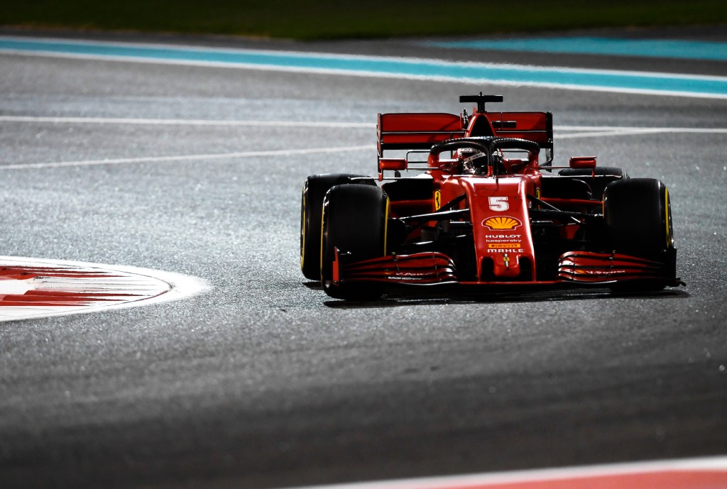 Sebastian Vettel taking a corner on F1 track in a Ferrari car