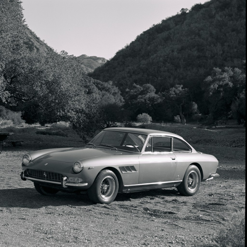 An image of a Ferrari 330 parked outside.