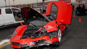 An image of a crashed Ferrari Enzo parked up on display.