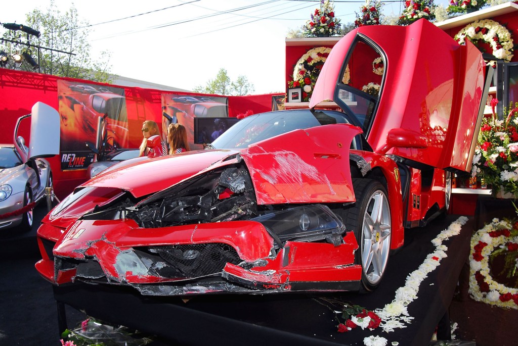 An image of a crashed Ferrari Enzo parked up on display.