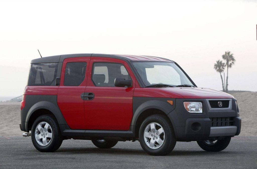 A red 2005 Honda Element sitting by the beach