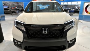 The front grille of a Honda Passport SUV on display an auto show