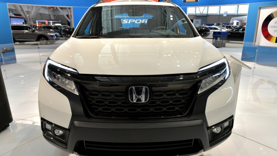 The front grille of a Honda Passport SUV on display an auto show