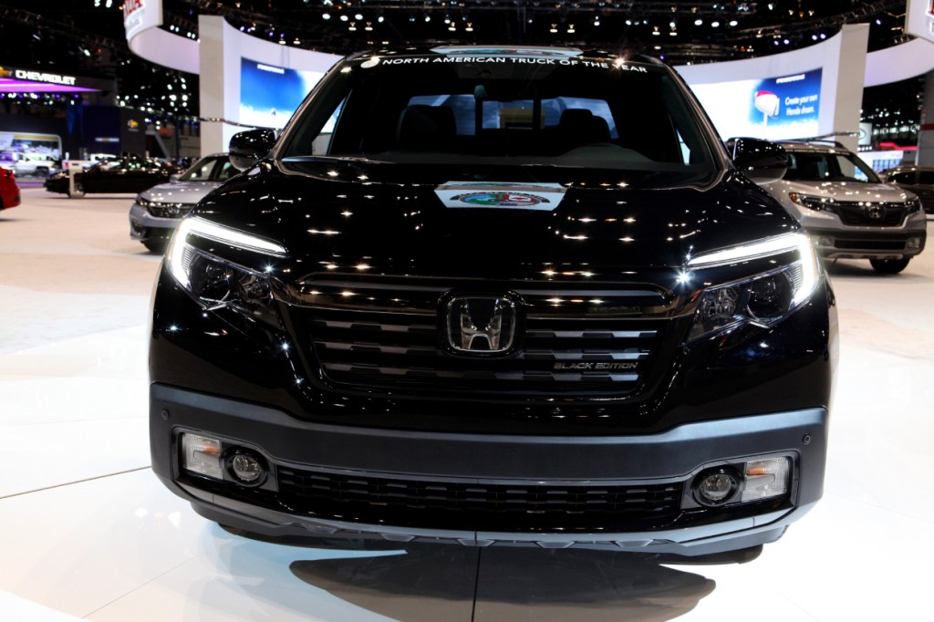 A black Honda Ridgeline on display at an auto show