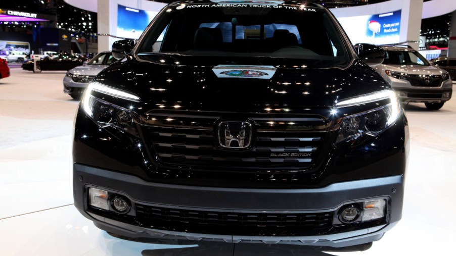A black Honda Ridgeline on display at an auto show