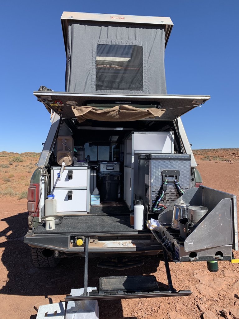 green 2018 Ford Raptor camper conversion in the desert