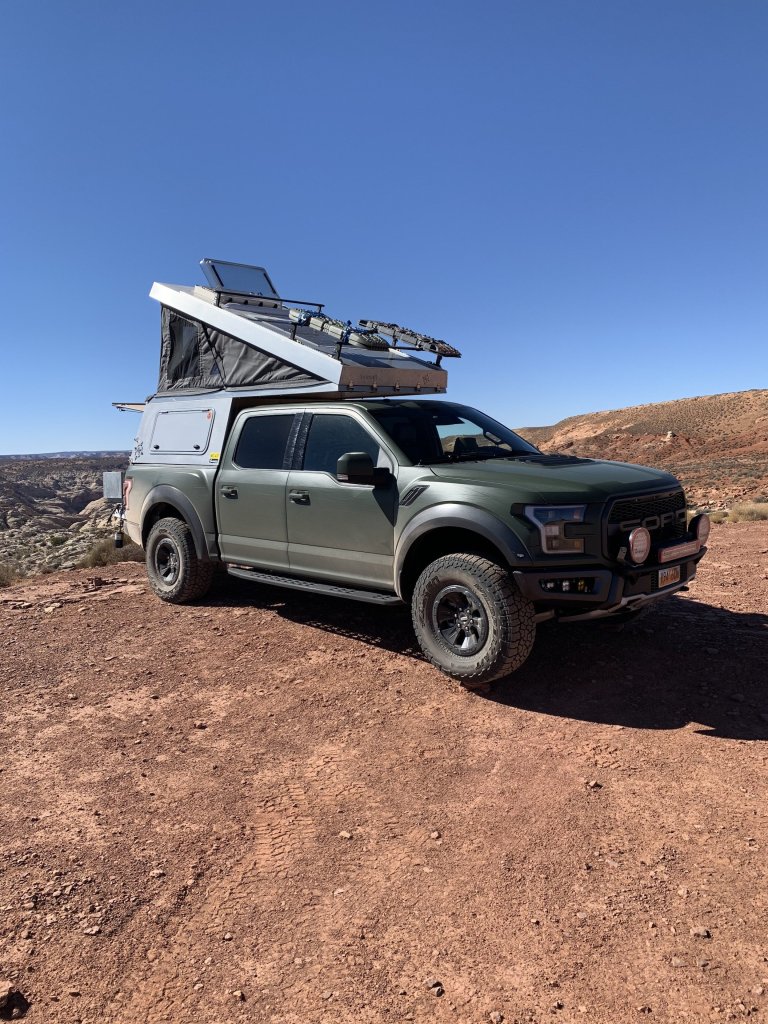 green 2018 Ford Raptor camper overland camper conversion in the desert