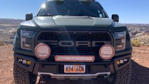 green 2018 Ford Raptor camper conversion in the desert