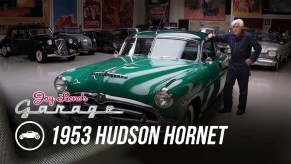 Jay Leno with his green 1953 Hudson Hornet coupe