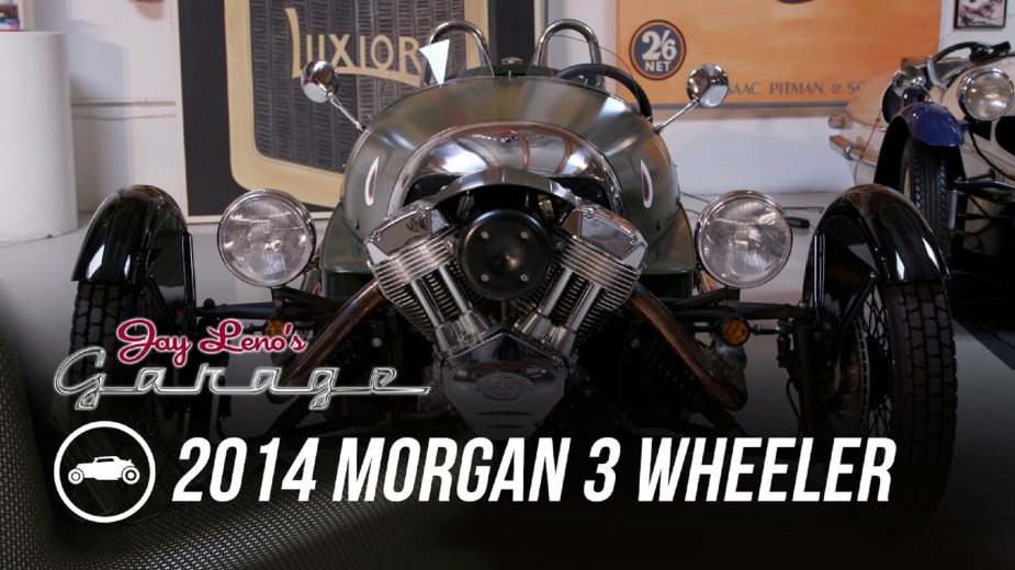 The front view of Jay Leno's green 2014 Morgan 3-Wheeler in his garage