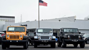 A U.S. flag flies over a car dealership.