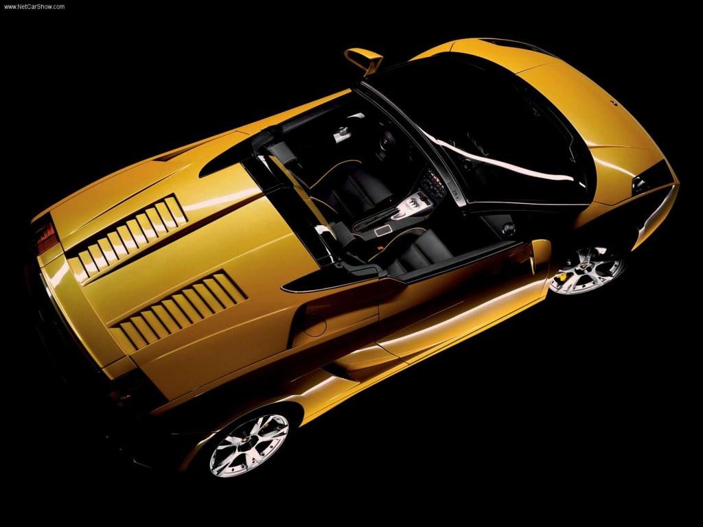 An image of a yellow Lamborghini Gallardo in a studio.