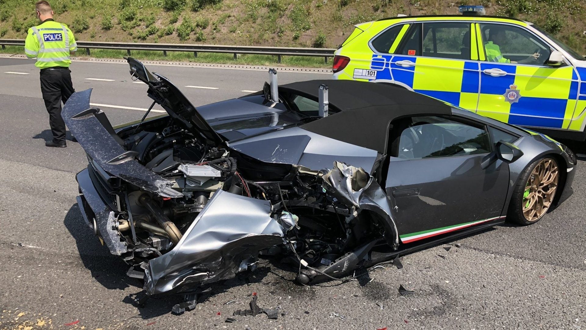 A wrecked Lamborghini Huracan Preformante Spyder sits on the M1