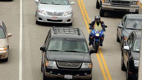 motorcyclist lane splitting in traffic