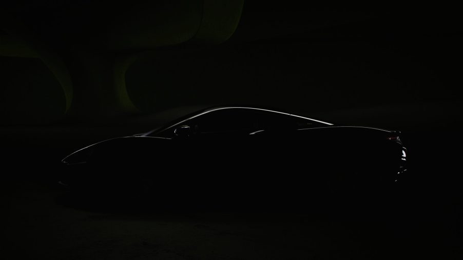 A dark imagine hiding everything about the 2022 McLarent Artura besides a sliver of light that highlights the car's silhouette