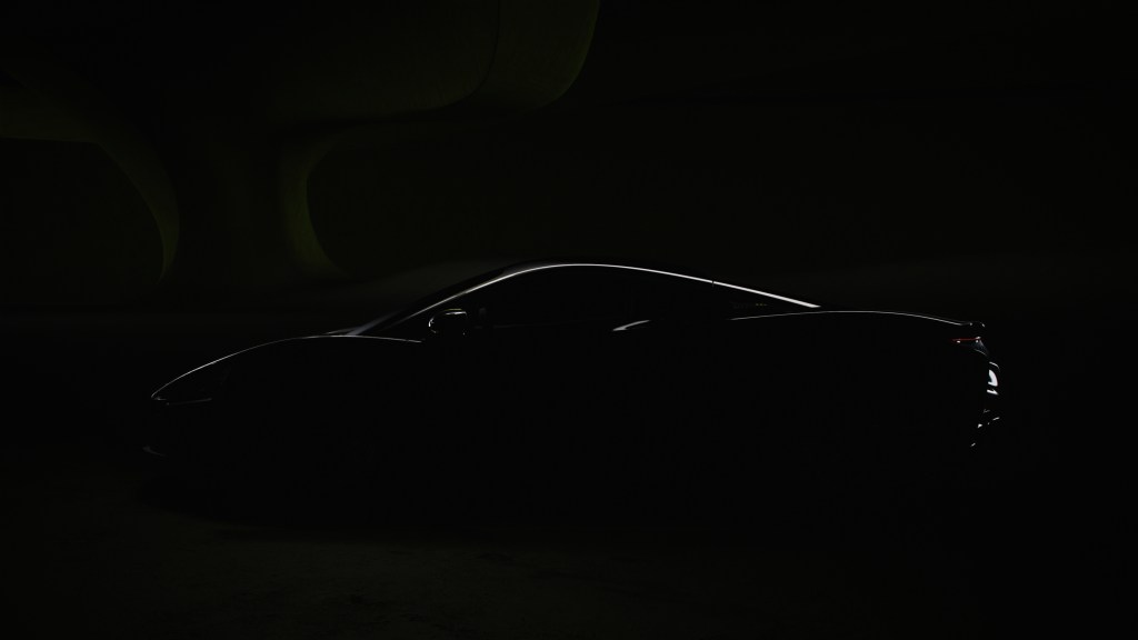 A dark imagine hiding everything about the 2022 McLarent Artura besides a sliver of light that highlights the car's silhouette