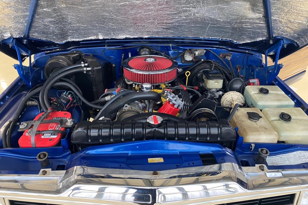 The engine bay of a modified blue 1991 Jeep Grand Wagoneer