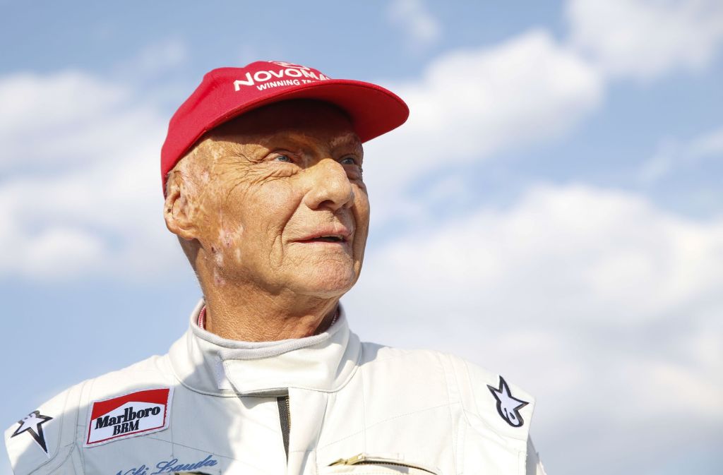 Niki Lauda at the 2018 Legends Race in Spielberg, Austria in a white racing suit and his trademark red hat