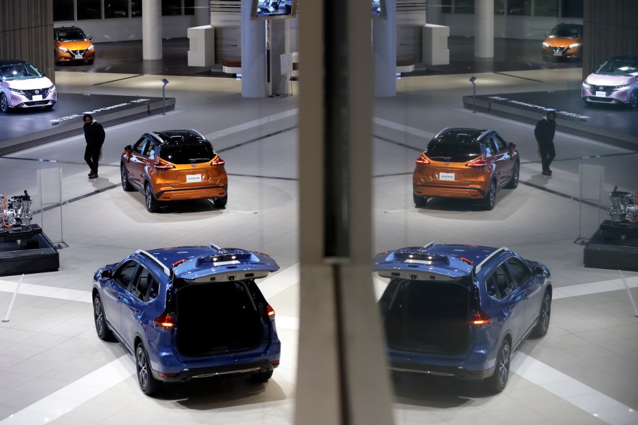 A visitor looks at a Nissan Kicks crossover sport utility vehicle (SUV) on display inside a showroom at the company's global headquarters