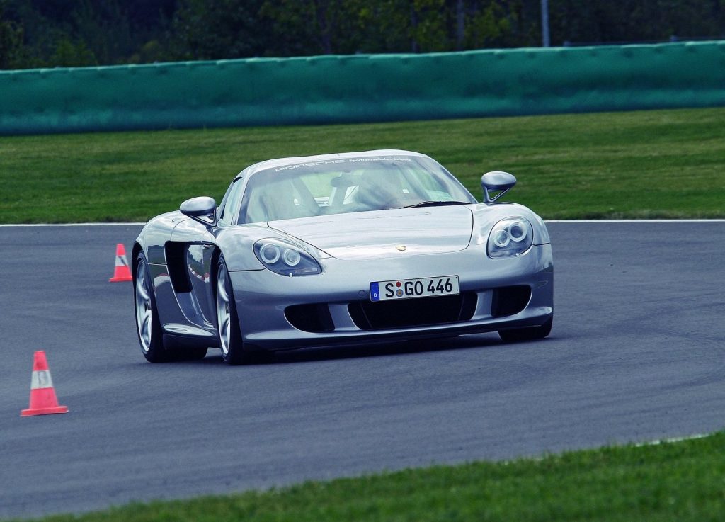 An image of a Porsche Carrera GT rolling down the road.