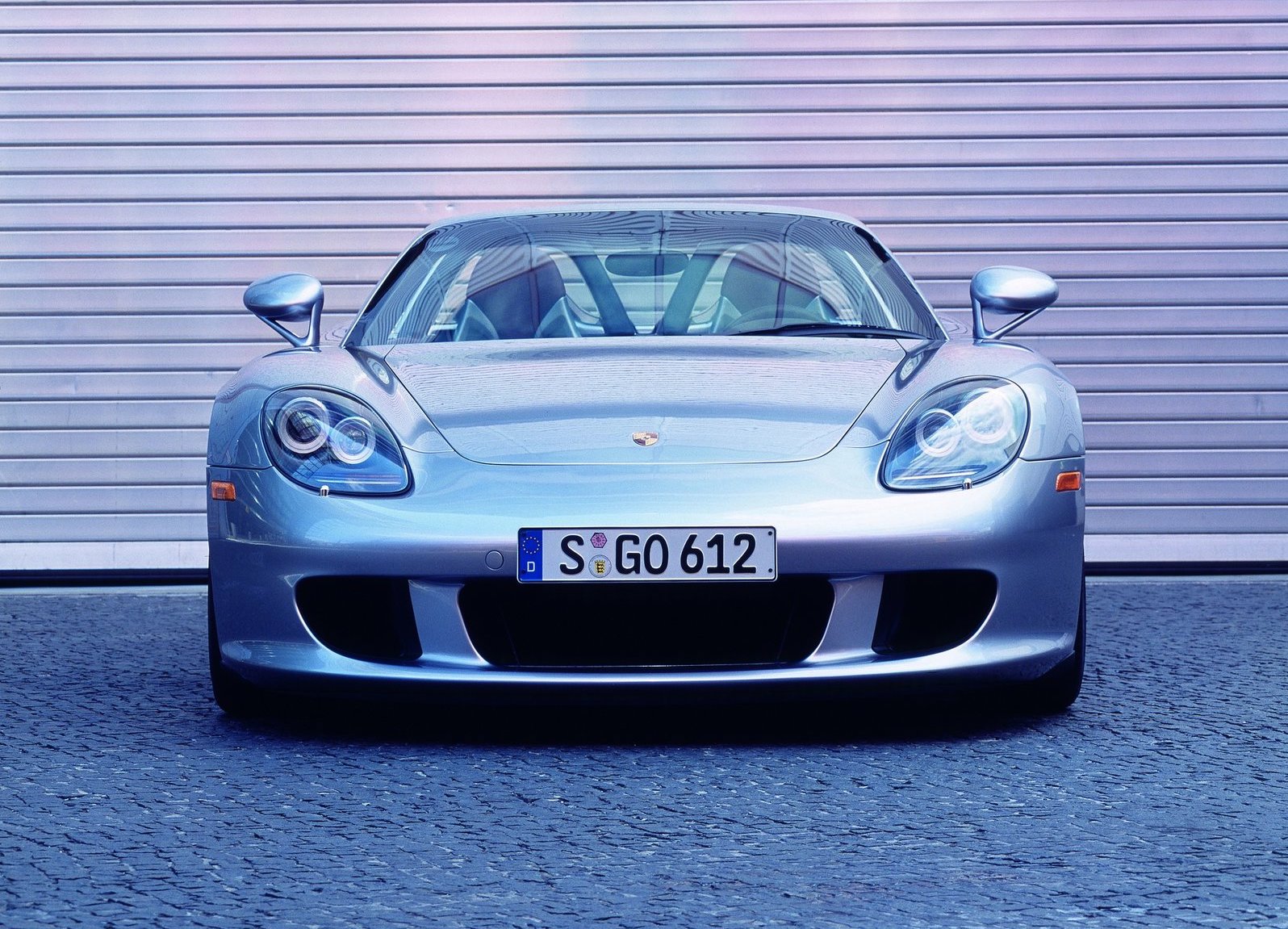 An image of a Porsche Carrera GT parked outside.