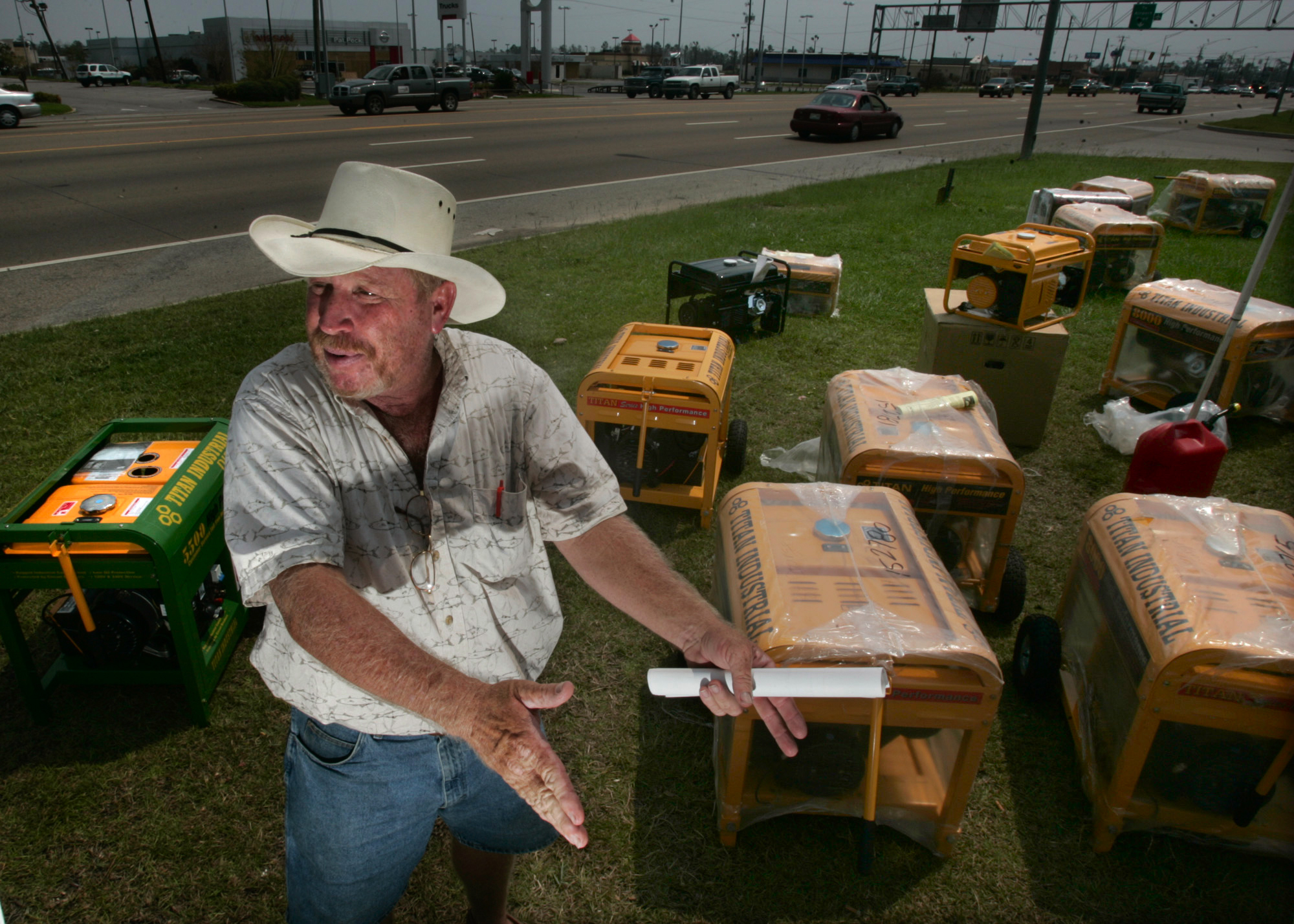 A man sets up some generators on display to sell them