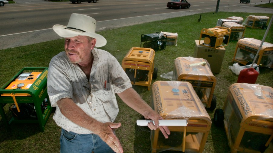 A man sets up some generators on display to sell them