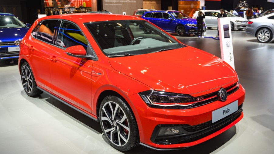 A red Volkswagen GTI on display at an auto show