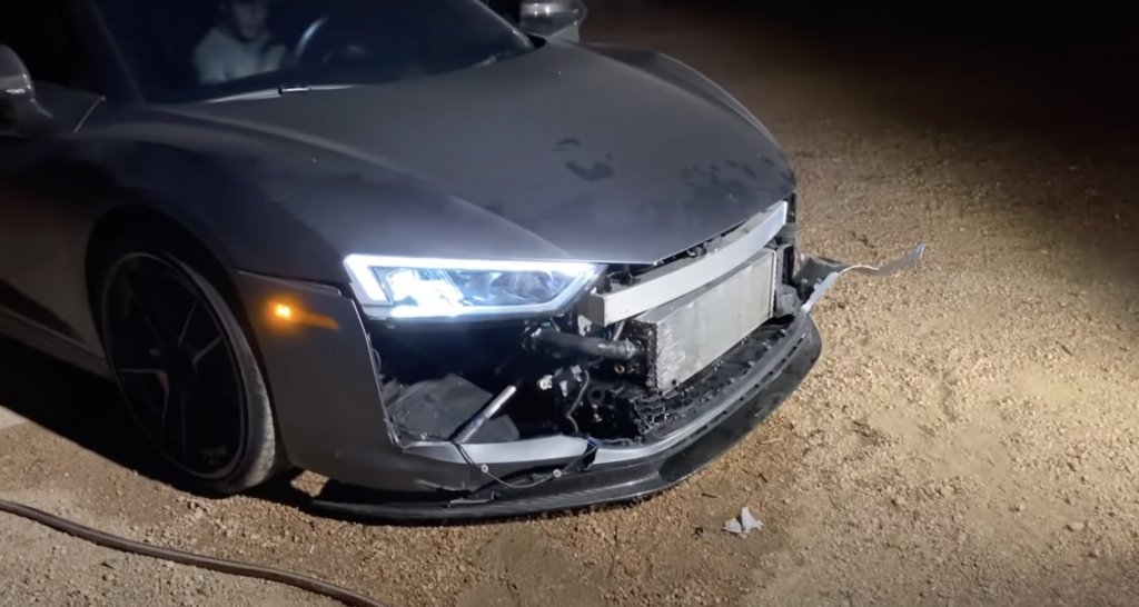 An image of a broken Audi R8 V10 out on a dirt road.