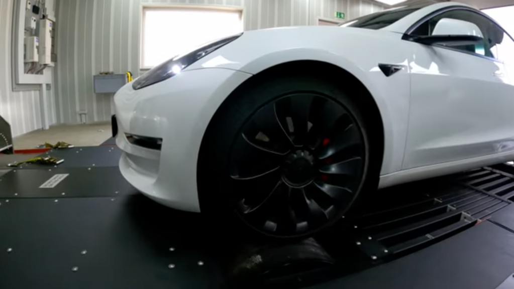 An image of a white Tesla Model 3 Performance on the dyno.