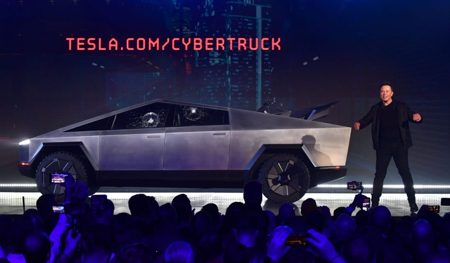 Tesla co-founder and CEO Elon Musk on stage with the newly unveiled all-electric battery-powered Tesla Cybertruck with broken glass on windows following a demonstation that did not quite go as planned