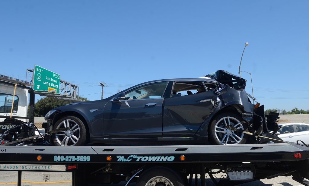 Blue Tesla on trailer after crash