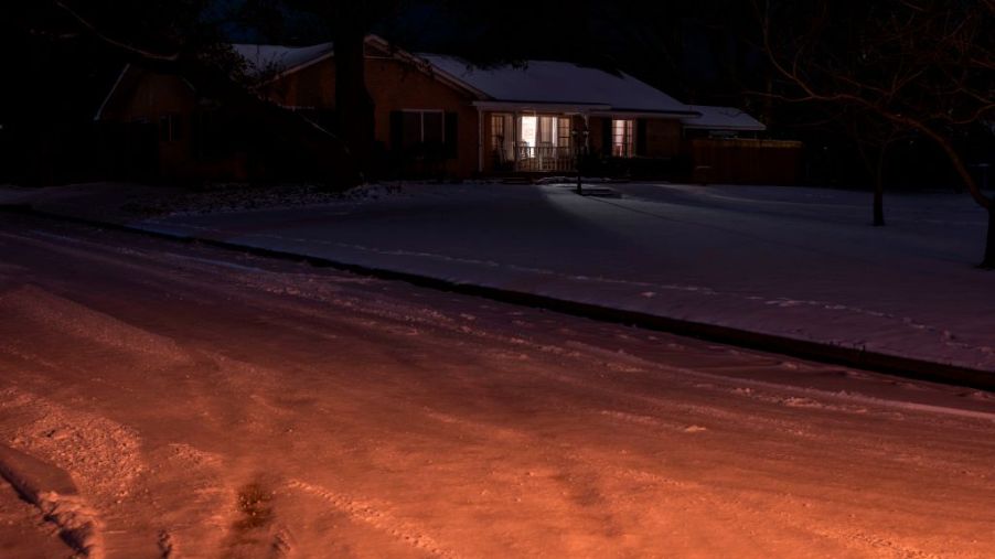 lone house with lights on in Texas power outage