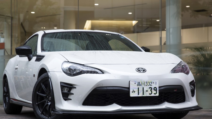 A white Toyota 86 on display at a dealership