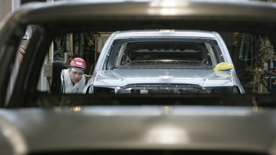 Workers assemble Toyota Tacoma trucks in a factory