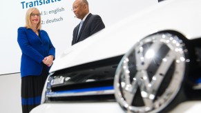 Two Volkswagen employees look on before a press conference
