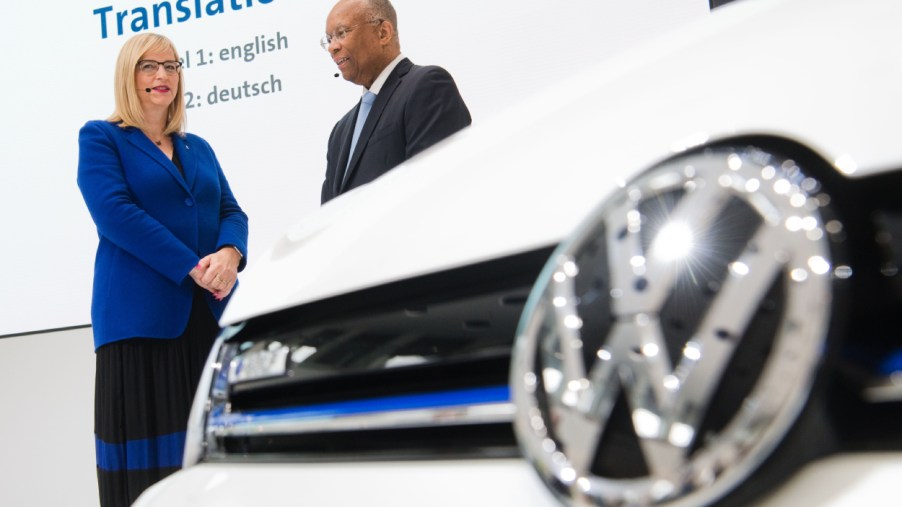Two Volkswagen employees look on before a press conference