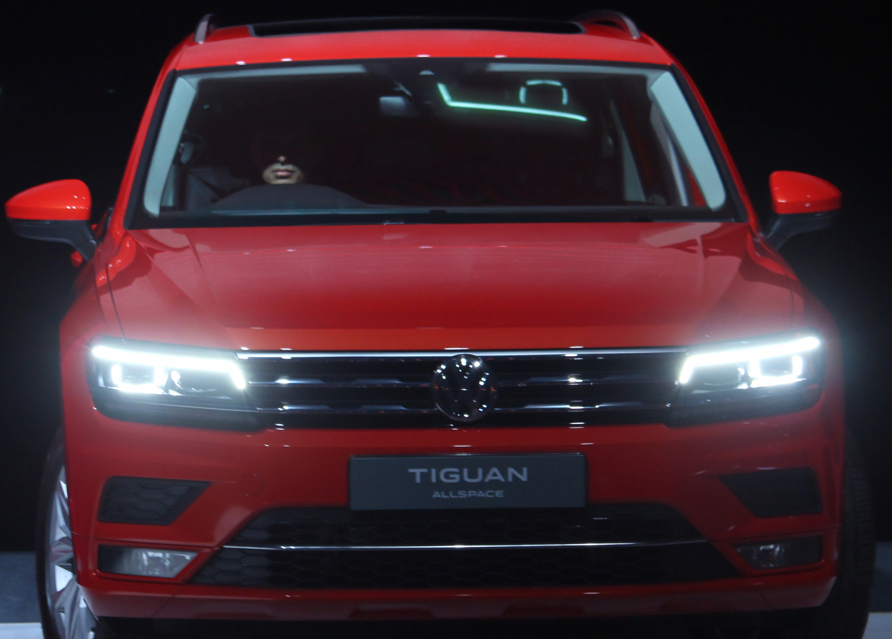 A Volkswagen Tiguan displayed with its headlights on