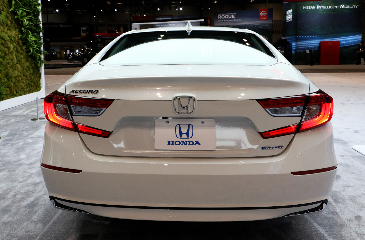 A white Honda Accord on display at an auto show