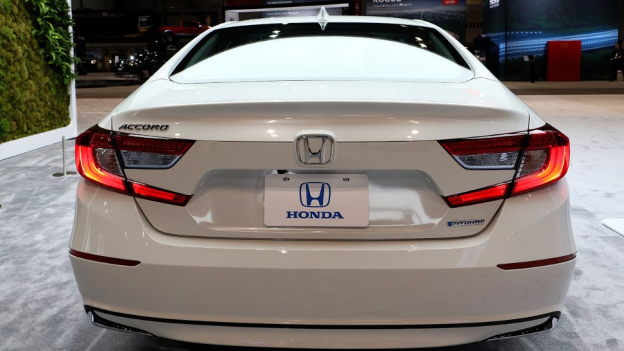 A white Honda Accord on display at an auto show