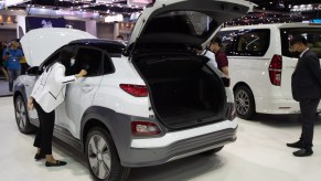 A white Hyundai Kona on display at an auto show