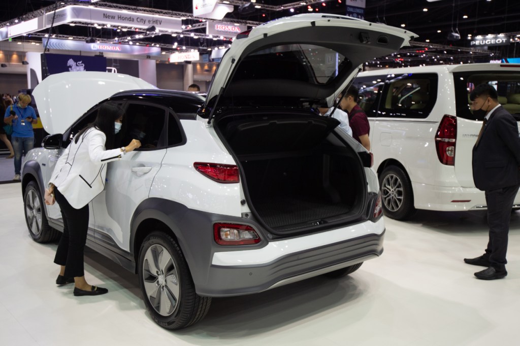 A white Hyundai Kona on display at an auto show