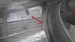 grainy image of truck plunging off of overpass