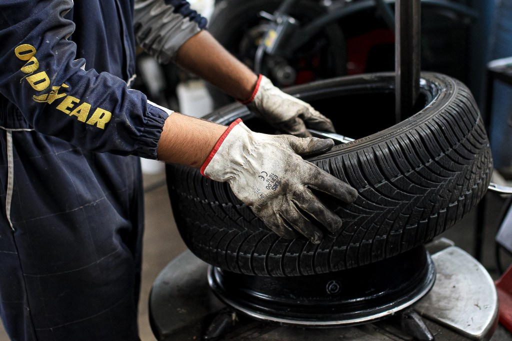 A mechanic working on a car tire.