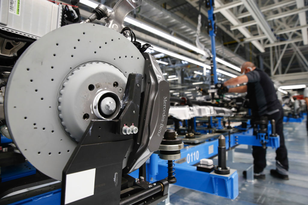 A Mercedes-Brenz brake disc on the chassis of a Mercedes S-Class as it moves across a production line